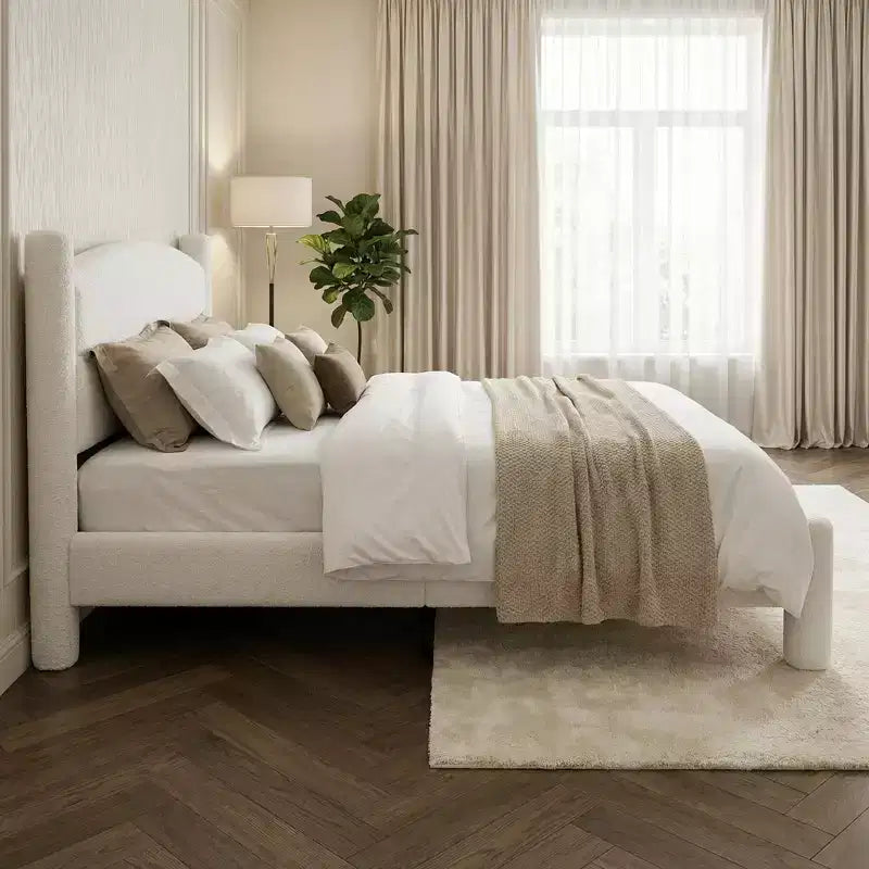 Base de cama tapizada con plataforma, cabecero redondo y patas cilíndricas